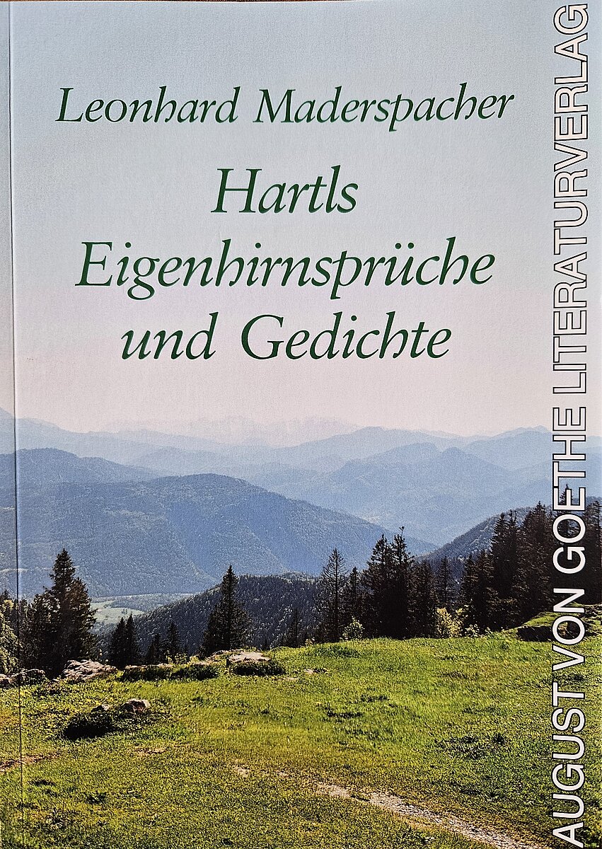 Der Buchtitel zeigt eine grüne Wiese mit dem heimischen Bergpanorama im Hintergrund
